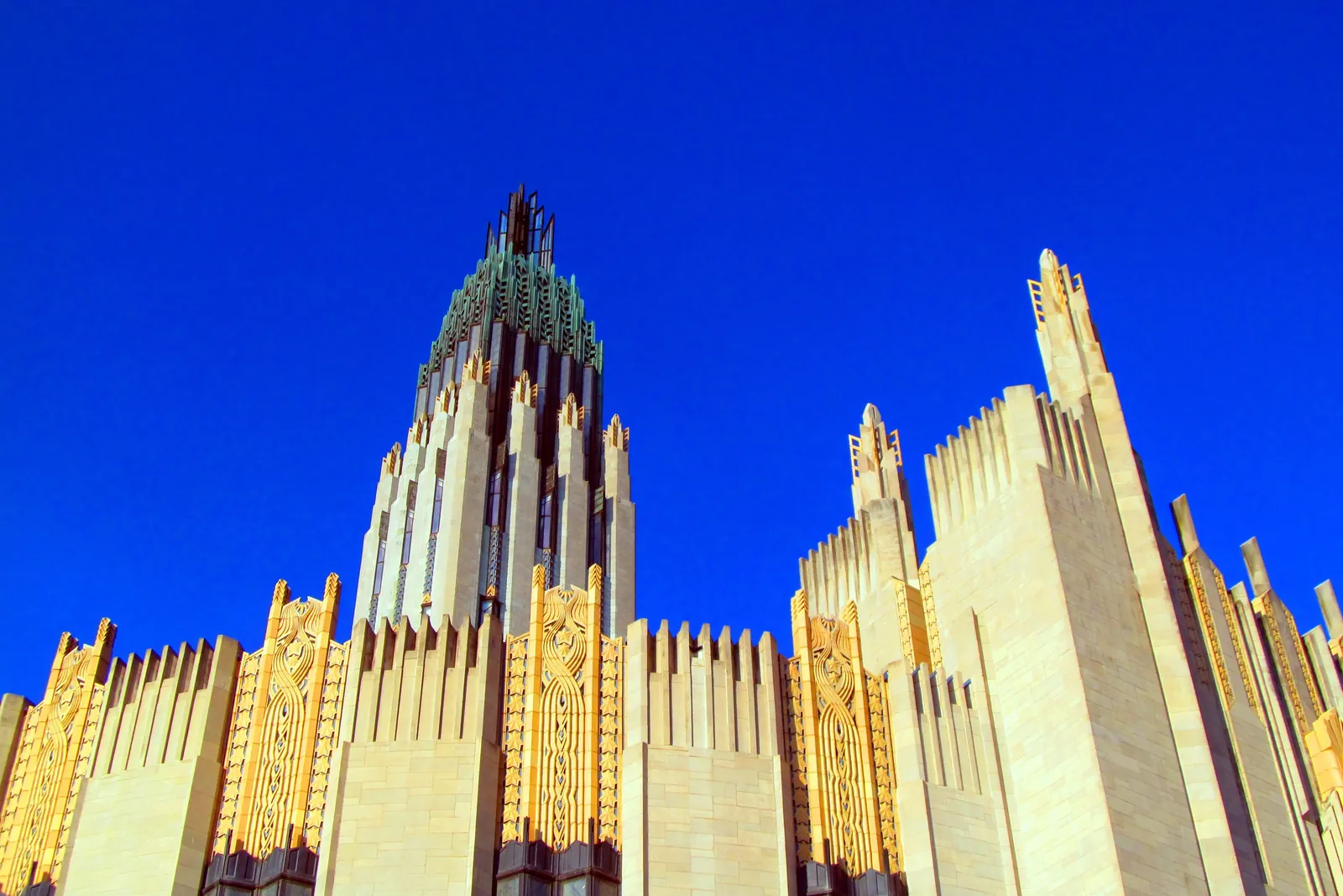 Sunlit geometric ornament on a limestone Art Deco facade